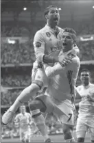  ?? DANIEL OCHOA DE OLZA, THE ASSOCIATED PRESS ?? Cristiano Ronaldo celebrates with Sergio Ramos, left, after scoring the opening goal against Atletico Madrid on May 2.