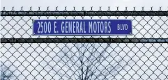  ?? ANTHONY LANZILOTE / BLOOMBERG FILES ?? A road sign for East General Motors Boulevard hangs outside the General Motors Co. Detroit-Hamtramck assembly plant in Detroit.