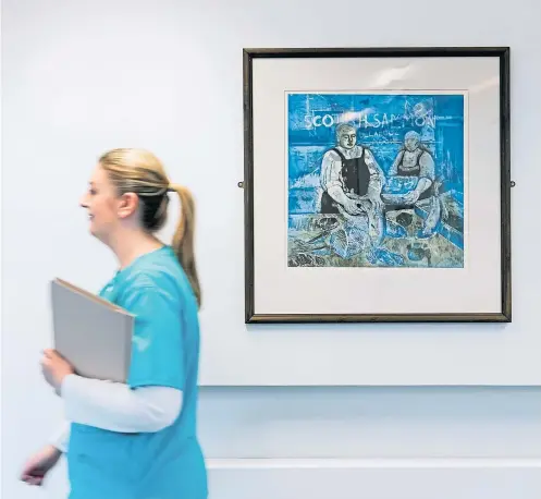  ?? ?? Lauren McIntyre, clinical nurse manager at Quarriers Epilepsy Centre in Govan, walks past a painting by Dundee artist Michael McVeigh titled Scottish Salmon, part of the Art in Healthcare collection
Picture Andrew Cawley