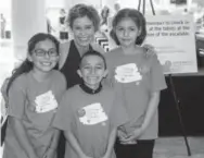  ??  ?? Leanna Clark, chair of the DPS Foundation board, with some of the students who served as greeters.