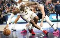  ?? ?? Los Angeles Lakers forward LeBron James, left, reaches for the ball against Dallas Mavericks guard Luka Doncic, right, Sunday during the second half of an NBA basketball game in Dallas. (AP photo/LM Otero)
