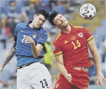  ??  ?? Wales striker Kieffer Moore vies for a header with Italy defender Alessandro Bastoni in Rome