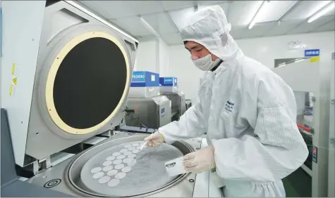  ?? PHOTOS PROVIDED TO CHINA DAILY ?? A technician from Shandong Novoshine Optoelectr­onics Co Ltd examines a product using advanced testing equipment.