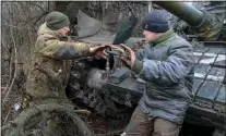  ?? ALEXEI ALEXANDROV - THE ASSOCIATED PRESS ?? Servicemen of the People’s Militia of Russian-controlled Donetsk region repair a tank damaged in fighting between Russian and Ukrainian forces, in the Russian-controlled Donetsk region, eastern Ukraine, on Monday.