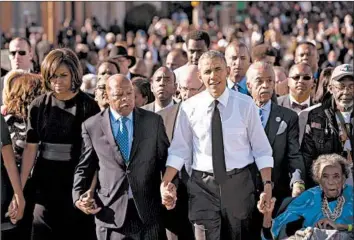  ?? SAUL LOEB/GETTY-AFP 2015 ?? Then-President Barack Obama walks with, from left, first lady Michelle Obama, U.S. Rep. John Lewis, the Rev. Al Sharpton and original marcher Amelia Boynton Robinson across the Edmund Pettus Bridge to mark the 50th anniversar­y of the Selma to Montgomery civil rights marches in Alabama.