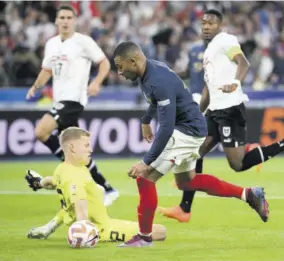  ?? (Photo: AFP) ?? France forward Kylian Mbappe runs with the ball against Austria goalkeeper Patrick Pentz (on ground) during the UEFA Nations League, League A Group 1 football match at Stade de France in Saint-denis, north of Paris, on Thursday.