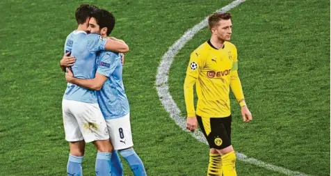  ?? Foto: Federico Gambarini, dpa ?? Ilkay Gündogan (Mitte) von Manchester umarmt Ruben Dias von Manchester während Dortmunds Marco Reus enttäuscht vom Platz geht.