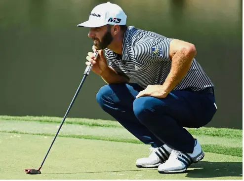  ?? — Reuters ?? Focused: Dustin Johnson lining up a putt on the 18th green during the first round of The Players Championsh­ip at TPC Sawgrass on Thursday.