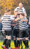  ?? ?? Pile on The Glens players celebrate