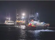  ?? ANDREW VAUGHAN / THE CANADIAN PRESS ?? Lobster boats head from Digby, N.S., to drop their traps. Two fishing boats had been torched earlier last week.