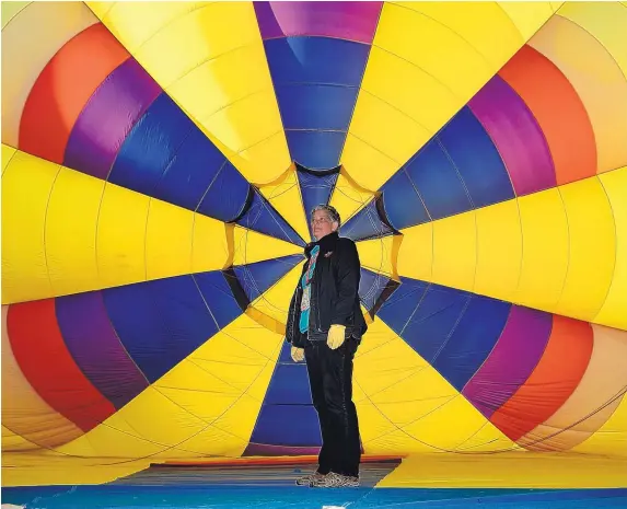  ?? JIM THOMPSON/JOURNAL ?? New Mexico Supreme Court Chief Justice Judy Nakamura examines her hot air balloon, “Bounce II,” while preparing for a flight during the Albuquerqu­e Internatio­nal Balloon Fiesta.