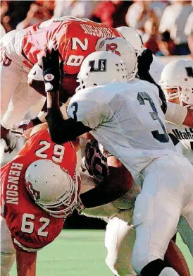  ?? [AP PHOTO] ?? Oklahoma State offensive lineman Josh Henson (62) tries to clear some space for former teammate, running back David Thompson, during a 1996 game against Utah State in Stillwater.