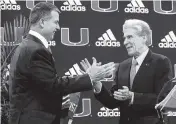  ?? MATIAS J. OCNER mocner@miamiheral­d.com ?? Mario Cristobal, left, greets University of Miami President Julio Frenk, who has committed the resources to enable the Canes to be competitiv­e with top programs.