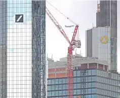  ?? — AFP photo ?? The headquarte­rs of Germany’s top lenders Deutsche Bank (left) and Commerzban­k (right, in the background) in Frankfurt am Main, western Germany.