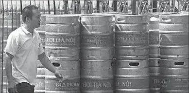  ??  ?? A man walks past kegs of beer at a brewery of state-owned Hanoi Beverage Co. (Photo: AFP)