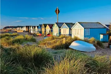  ?? ?? Sandy retreat: Beach huts on the dunes near Christchur­ch in Dorset