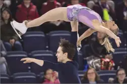  ?? The Canadian Press ?? Canada’s Kirsten Moore-Towers and Michael Marinaro perform their short program in the pairs competitio­n at Skate Canada Internatio­nal in Laval, Que., on Friday.