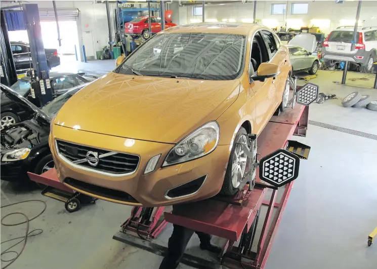  ?? DAVE HALLIDAY/FILES ?? Even a simple routine wheel alignment can necessitat­e the recalibrat­ion of sensors that keep high-maintenanc­e assisted-driving systems functionin­g properly.