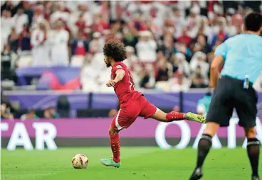  ?? ?? Qatar's Akram Afif scores against Jordan in the Asian Cup final on Saturday