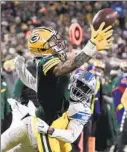  ?? Morry Gash Associated Press ?? CHRISTIAN WATSON catches a pass for a first down as the Lions’ Amani Oruwariye defends at Lambeau Field.