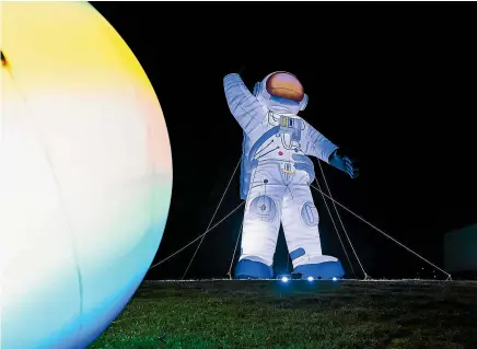  ?? ?? A 30m-tall spaceman is among the attraction­s at the Illuminate Light and Sound Experience event at Nelson’s Founders Heritage Park.