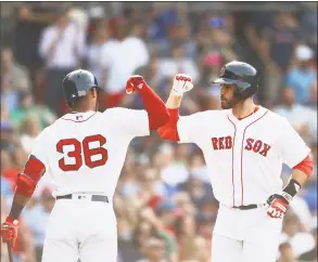 ?? Omar Rawlings / Getty Images ?? Boston’s J.D. Martinez, right, celebrates with Eduardo Nunez after hitting a two-run home run in the top of the fifth inning against the Chicago White Sox at Fenway Park on Saturday.