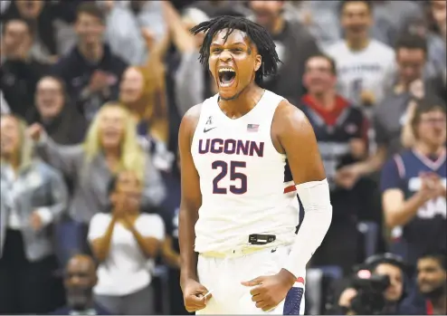  ?? Stephen Dunn / Associated Press ?? UConn’s Josh Carlton screams after blocking a shot in the second half against Sacred Heart.