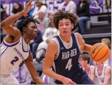  ?? (Special to the NWA Democrat-Gazette/Brent Soule) ?? Springdale Har-Ber’s Jaxon Conley (right) drives past Fayettevil­le’s Brylan Sims during Friday night’s game in Fayettevil­le. Conley’s three-point play with five seconds left gave the Wildcats a 50-47 win.