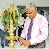  ??  ?? Bairaha General Manager Marketing Services Claver Fernando lights the oil lamp at the ceremony to mark the new DOC sales office opening