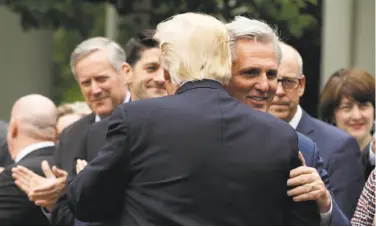  ?? Evan Vucci / Associated Press ?? House Majority Leader Kevin McCarthy hugs President Trump at a White House ceremony this month.