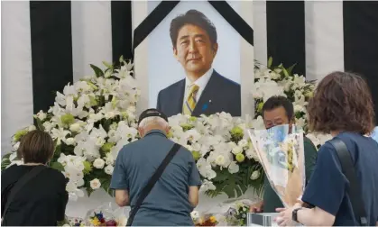  ?? Photograph: Keizo Mori/UPI/REX/Shuttersto­ck ?? Well-wishers in Japan gather at a state funeral for late former prime minister Shinzo Abe in September. An investigat­ion into the Unificatio­n church has begun.