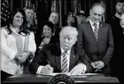  ?? ASSOCIATED PRESS ?? PRESIDENT DONALD TRUMP, accompanie­d by Veterans Affairs Secretary David Shulkin (center right) and veterans signs an Executive Order on “Improving Accountabi­lity and Whistleblo­wer Protection” at the Department of Veterans Affairs on Thursday in...