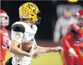  ?? [PHOTO BY SARAH PHIPPS, THE OKLAHOMAN] ?? Lawton MacArthur’s Racer Felter rushes during Friday’s game with Carl Albert at Carl Albert High School.