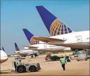  ?? Scott Olson Getty Images ?? UNITED will pare its domestic flights by 10% and internatio­nal ones by 20% in April and possibly May.