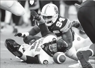  ?? Canadian Press photo ?? Ottawa Redblacks quarterbac­k Trevor Harris (7) fumbles the ball as Toronto Argonauts defensive end Victor Butler (94) completes the tackle during first half CFL action in Toronto, Monday.