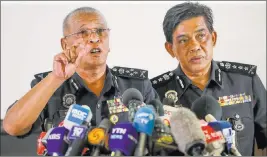  ?? VINCENT THIAN/ THE ASSOCIATED PRESS ?? Deputy National Police Chief of Malaysia Noor Rashid Ibrahim, left, speaks as Selangor Police Chief Abdul Samah Mat listens during a news conference Sunday at police headquarte­rs in Kuala Lumpur, Malaysia. Noor Rashid said four North Korean suspects in...