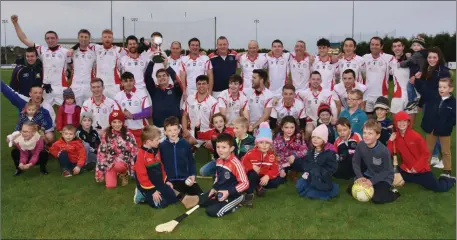  ??  ?? Team captain Colin Hawkins raises the cup in triumph as Monageer-Boolavogue celebrate their breakthrou­gh success.