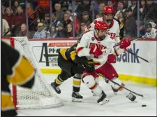  ?? DANIEL BRENNER — SPECIAL TO THE DENVER POST ?? Defenseman Sean Behrens of the Denver Pioneers moves the puck behind the net in the third period against Colorado College on Nov. 3at Magness Arena.