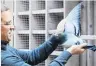  ?? PHOTO: REUTERS ?? Nikolaas Gyselbrech­t, of Pipa auction house, shows off a female pigeon named New Kim which has set a world record price at auction.