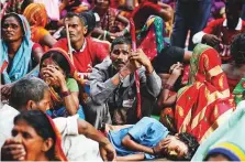  ?? AP ?? A child sleeps among protesters. Rural areas are home to about two-thirds of India’s 1.3 billion people.