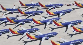  ??  ?? Southwest Airlines Boeing 737 Max aircraft are parked in Victorvill­e, Calif., after being grounded in March.