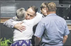  ?? EDMUND D. FOUNTAIN / NEW YORK TIMES ?? Baton Rouge Police Chief Carl Dabadie, Jr. is embraced on Thursday during a vigil at Healing Place Church in Baton Rouge, La., for three law enforcemen­t officers who were shot and killed on July 17.