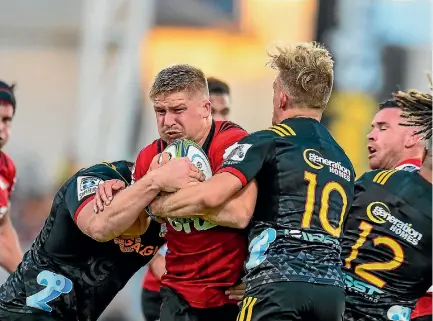  ?? PHOTOSPORT ?? Crusaders centre Jack Goodhue collides with Chiefs first five-eighth Damian McKenzie (right) during the 45-23 win in Christchur­ch on Saturday night.