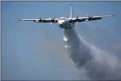  ?? RFS ?? In this undated photo released from the Rural Fire Service, a C-130 Hercules plane called “Thor” drops water during a flight in Australia.