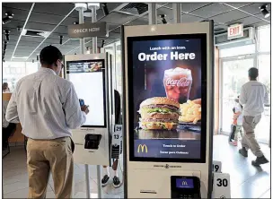  ?? Chicago Tribune/ANTONIO PEREZ ?? McDonald’s is rolling out ordering kiosks in many of its restaurant­s across the country. The company has also created the role of “guest experience leader” to help customers navigate the kiosks.