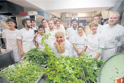  ??  ?? LEFT
Ana Roš, a chef at restaurant Hiša Franko poses with staff in the kitchen in Kobarid, Slovenia.