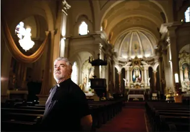  ?? DAI SUGANO — STAFF PHOTOGRAPH­ER ?? The Rev. António Silveira, a native of the Azores, stands inside Five Wounds Portuguese National Church in San Jose on Friday. Silveira, a longtime parishione­r who was married at the church in 1977, became its pastor in 2013, two years after his wife died.