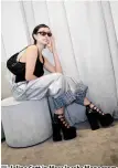  ?? ?? Jeline Catt in Marc Jacobs Monogram Oversized Jeans, Kiki Ankle Boot, and Rhinestone Small Curve bag.