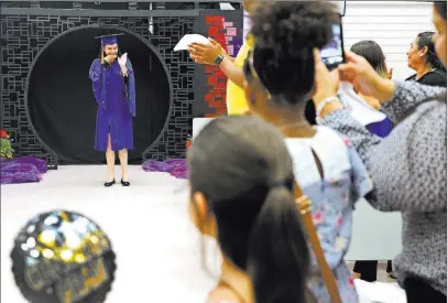  ?? Rachel Aston ?? Las Vegas Review-journal @rookie__rae The crowd applauds Natalia Martinez on Wednesday during the Helen J. Stewart School graduation ceremony.