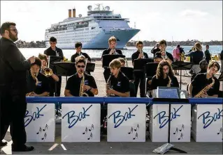  ?? PHOTOS BY GREG LOVETT / THE PALM BEACH POST ?? The Bak Middle School of the Arts Jazz band plays as the Grand Classica cruise ship arrives at the Port of Palm Beach on Friday in Riviera Beach. The Grand Classica and its sister ship, the Grand Celebratio­n, are expected to carry as many as 250,000...